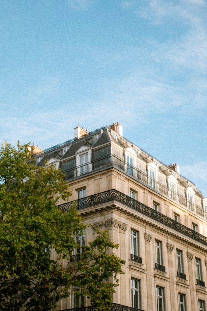 our-journey-01 Captivating view of Paris Haussmann architecture with clear blue sky. Iconic Parisian architecture captured beautifully.