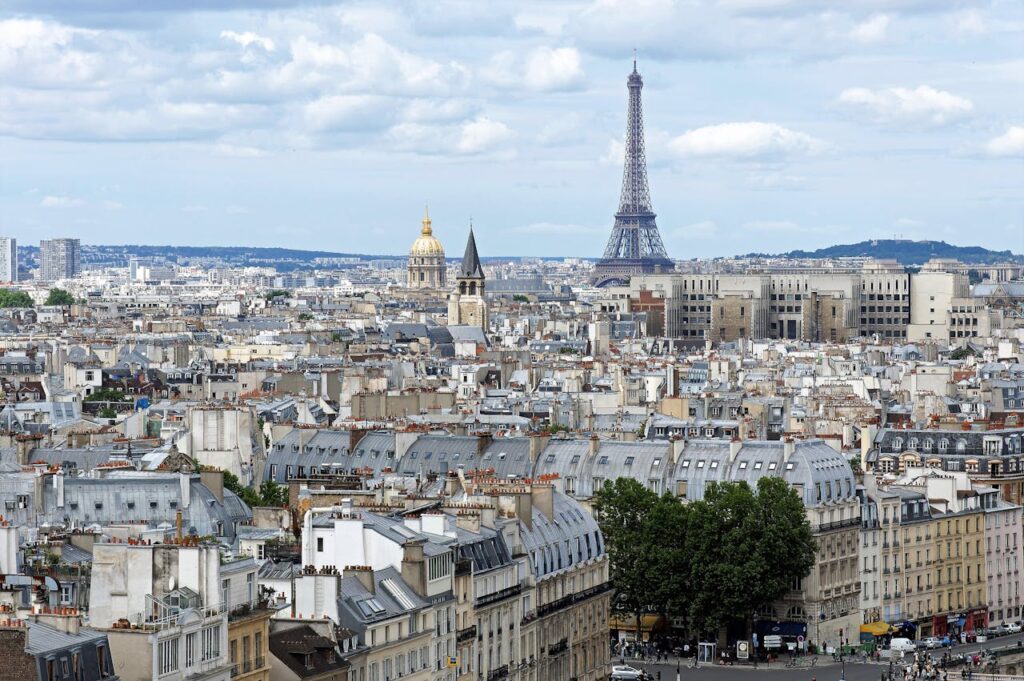 Stunning aerial shot of Paris cityscape featuring the iconic Eiffel Tower and historic architecture.